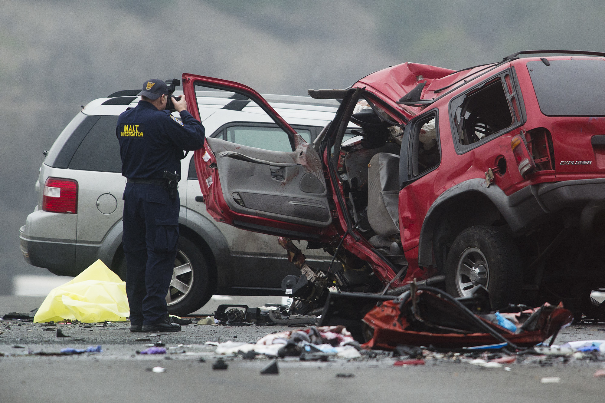 Officials investigate the scene of a multiple vehicle accident where 6 people were killed on the westbound Pomona Freeway in Diamond Bar, Calif. on Sunday morning, Feb. 9, 2013. Authorities say a wrong-way driver caused the pre-dawn crash that left six people dead.  (AP Photo/San Gabriel Valley Tribune,Watchara Phomicinda) MAGS OUT, NO SALES MANDATORY CREDIT